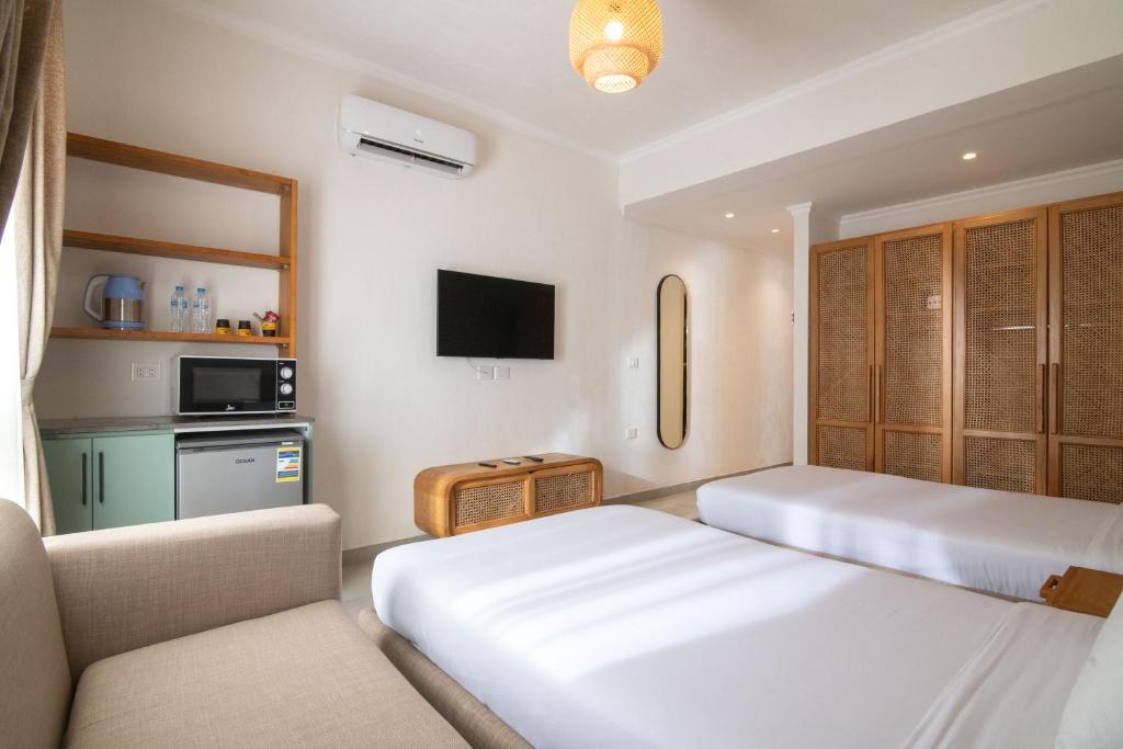 Postel nebo postele na pokoji v ubytování Ios Hotel & Village