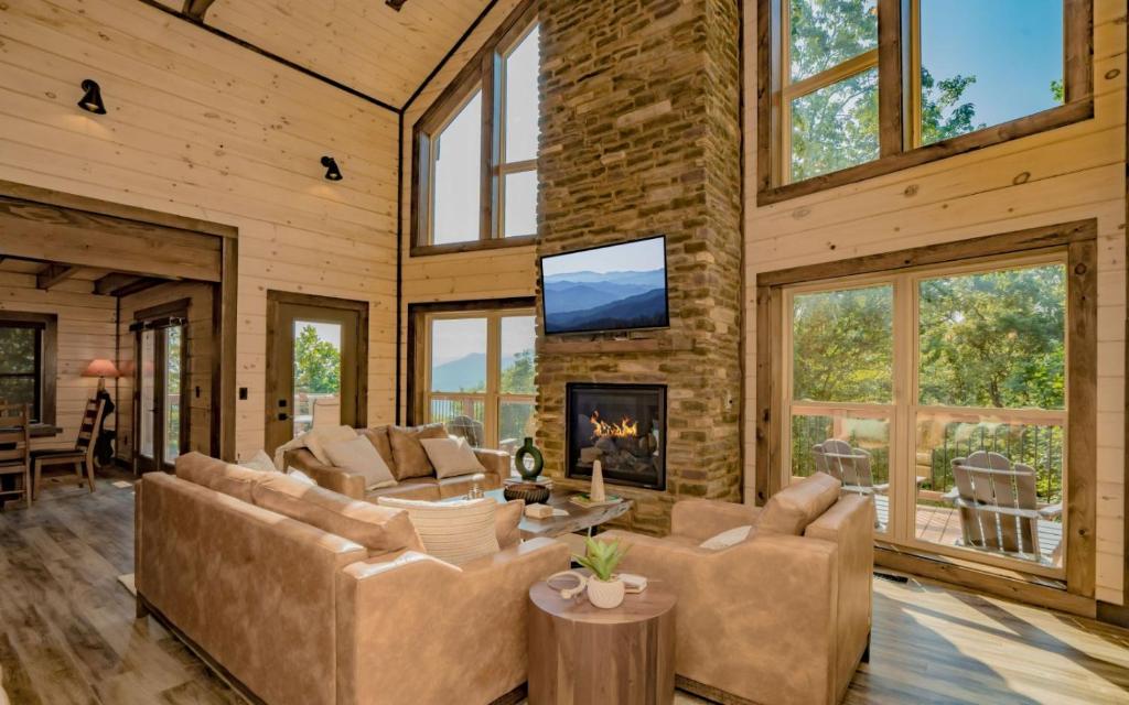 a living room with couches and a fireplace at Smoky Mountain Skies in Gatlinburg