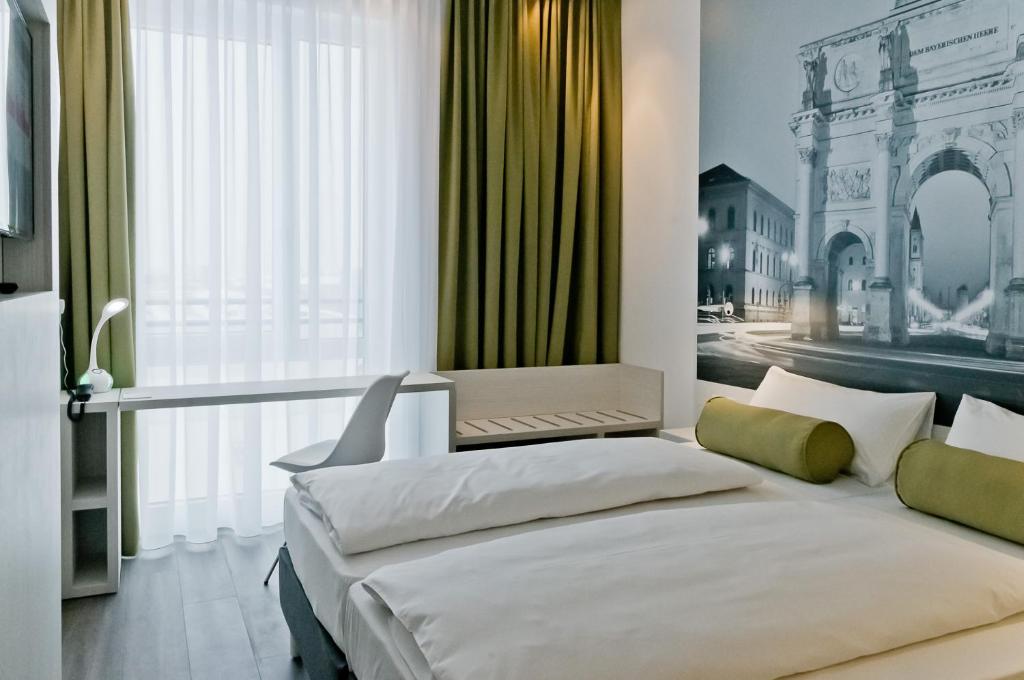 a bedroom with two beds and a large window at Super 8 by Wyndham Munich City North in Munich