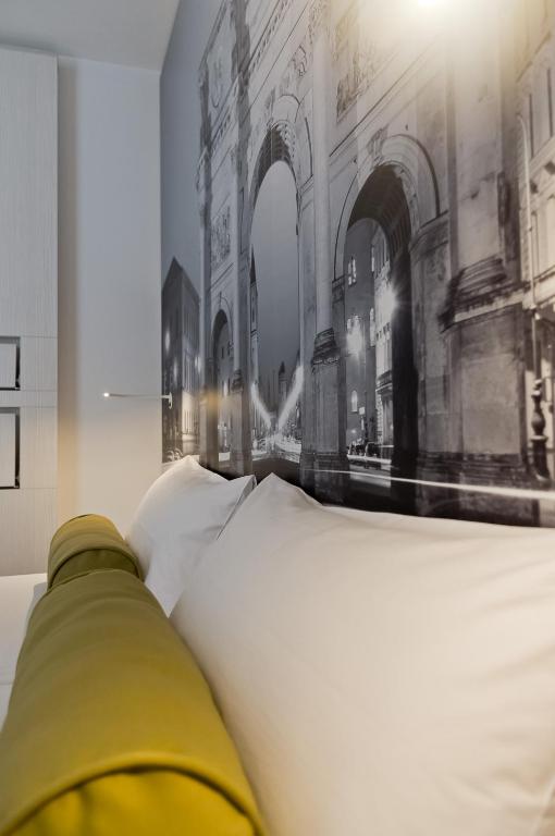 a bed with a picture of a building on the wall at Super 8 by Wyndham Munich City North in Munich
