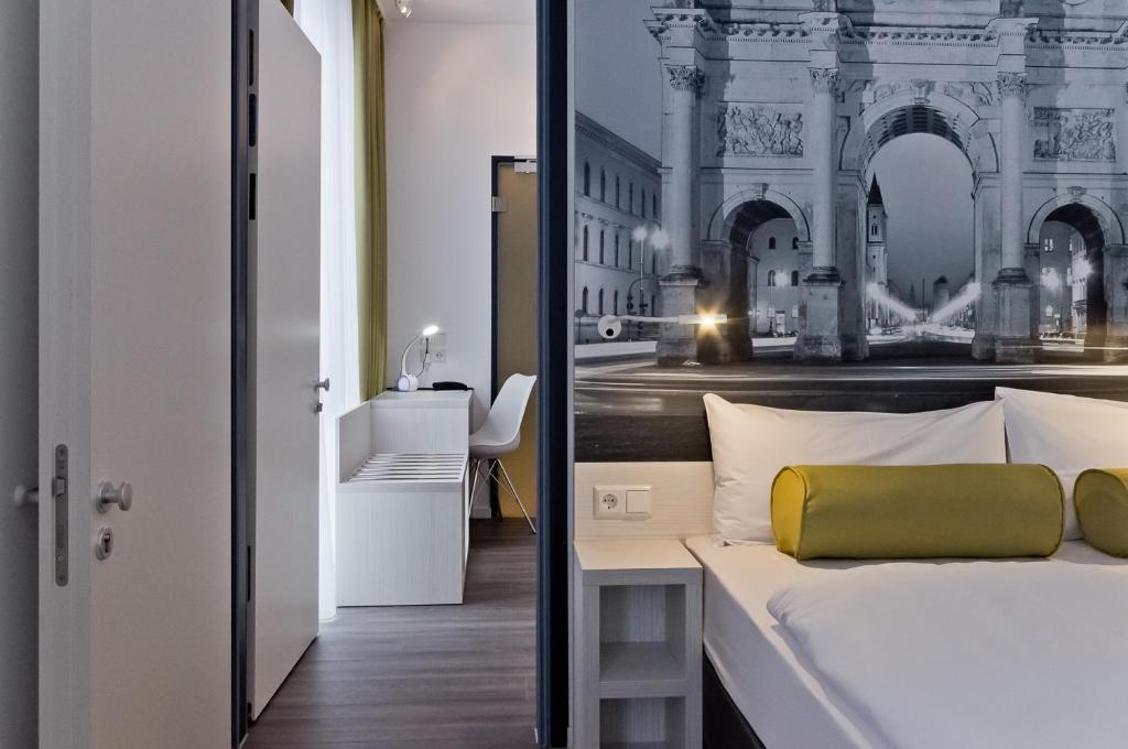 a bedroom with a bed with a picture of a building at Super 8 by Wyndham Munich City North in Munich