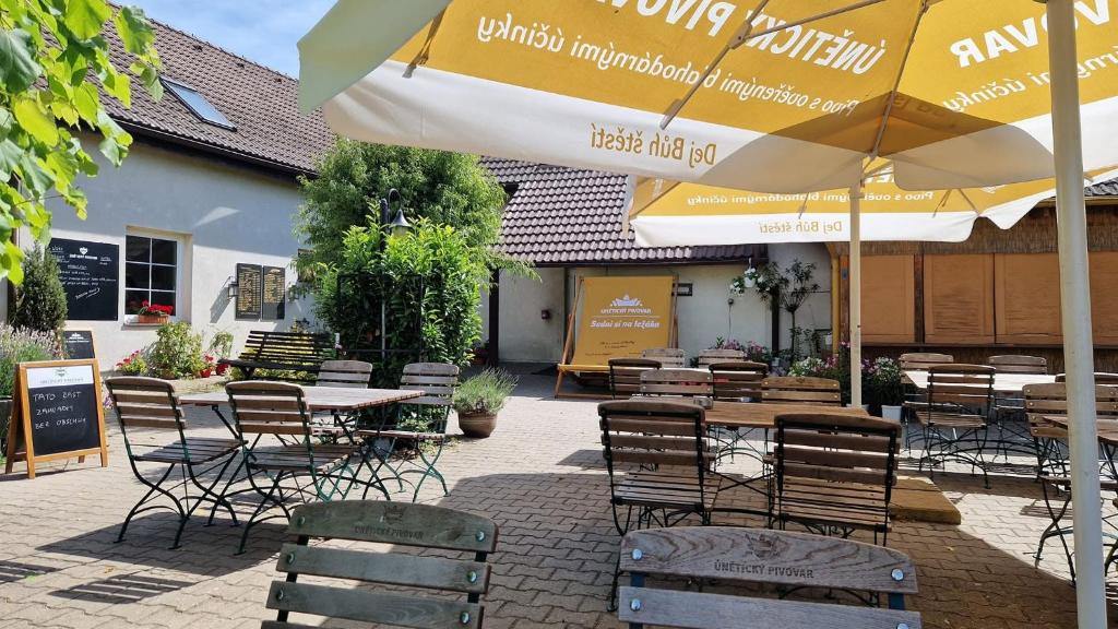 a patio with tables and chairs and an umbrella at Apartment Drahuska in Prague