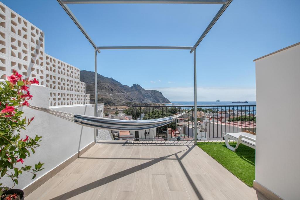 a hammock on a balcony with a view of the ocean at Atlantic Sunrise in Santa Cruz de Tenerife