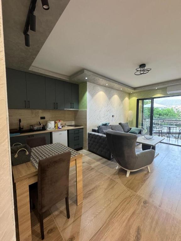 a kitchen and living room with a couch and a table at Kasia in Budva