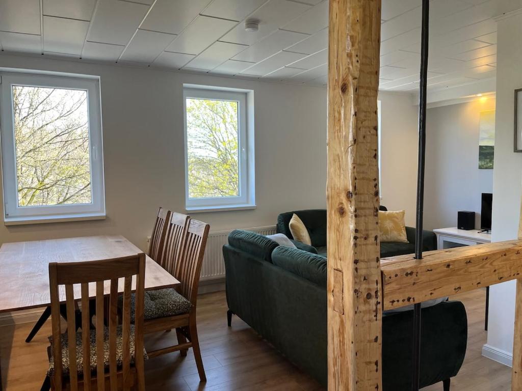 a living room with a couch and a table at Ferienhaus Wäschegrund in Sankt Andreasberg
