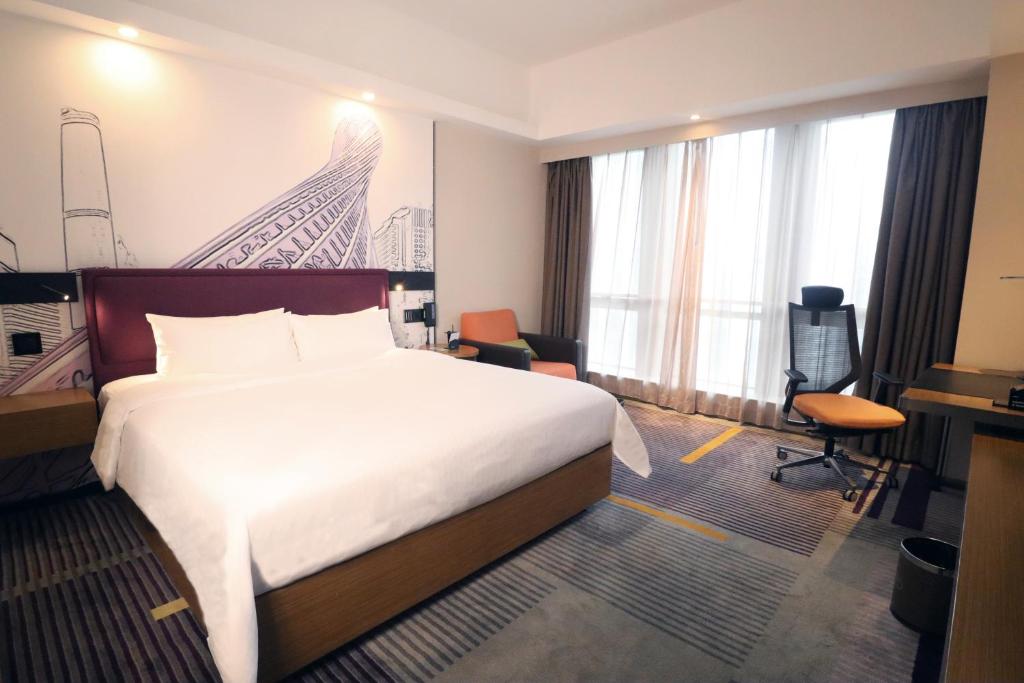 Postel nebo postele na pokoji v ubytování Hampton by Hilton Guangzhou Zhujiang New Town - Free Shuttle Bus to Canton Fair