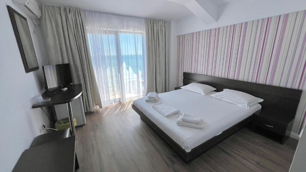 En eller flere senge i et værelse på Vila Sunrise Costinesti