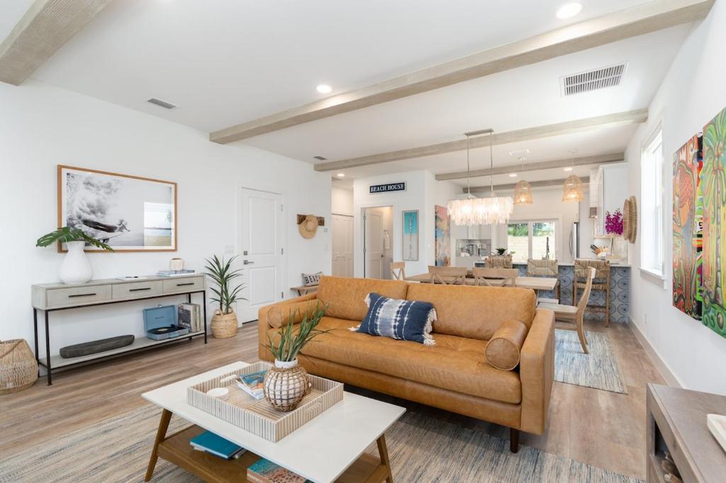 una sala de estar con un sofá y una mesa en Sun Seekers Beach House- Steps from Butler Beach, en St. Augustine