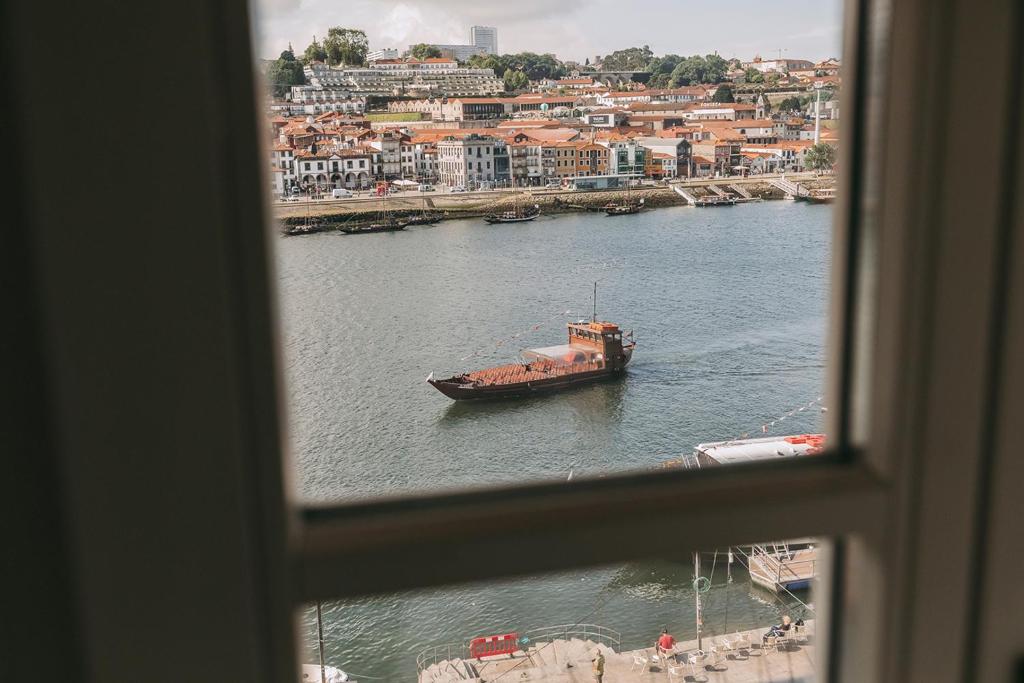 a boat in the water from a window at Gran Cruz House in Porto