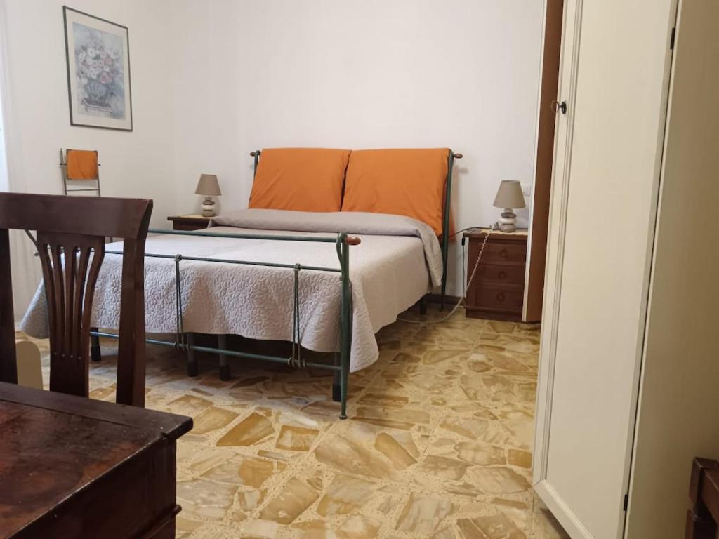 a bedroom with a bed and a wooden floor at Stella di Mare in Scarlino