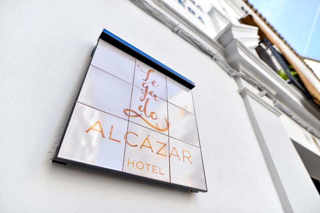 a sign for a alaza hotel on a building at Hotel Legado Alcazar in Seville