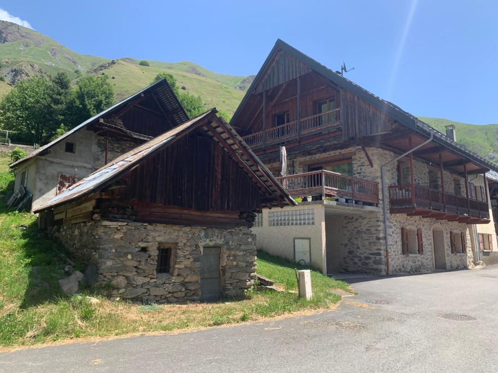 a large wooden house with a balcony on top of it at Le Chalet des Séraphins in Saint-Sorlin-dʼArves
