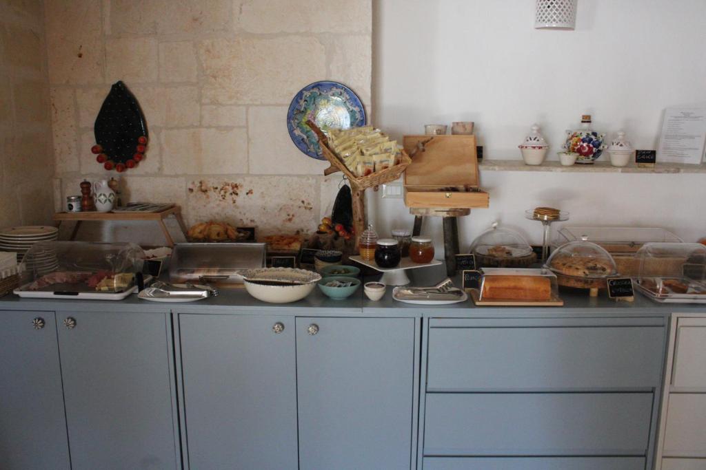 a kitchen with a counter with alot of food on it at Masseria della Piana in Villanova di Ostuni