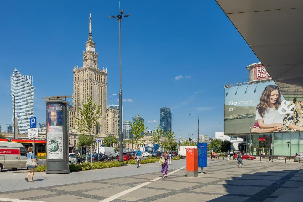 a city with people walking on a city street at Beautiful Apartment with Balcony in Heart of Warsaw by Noclegi Renters in Warsaw