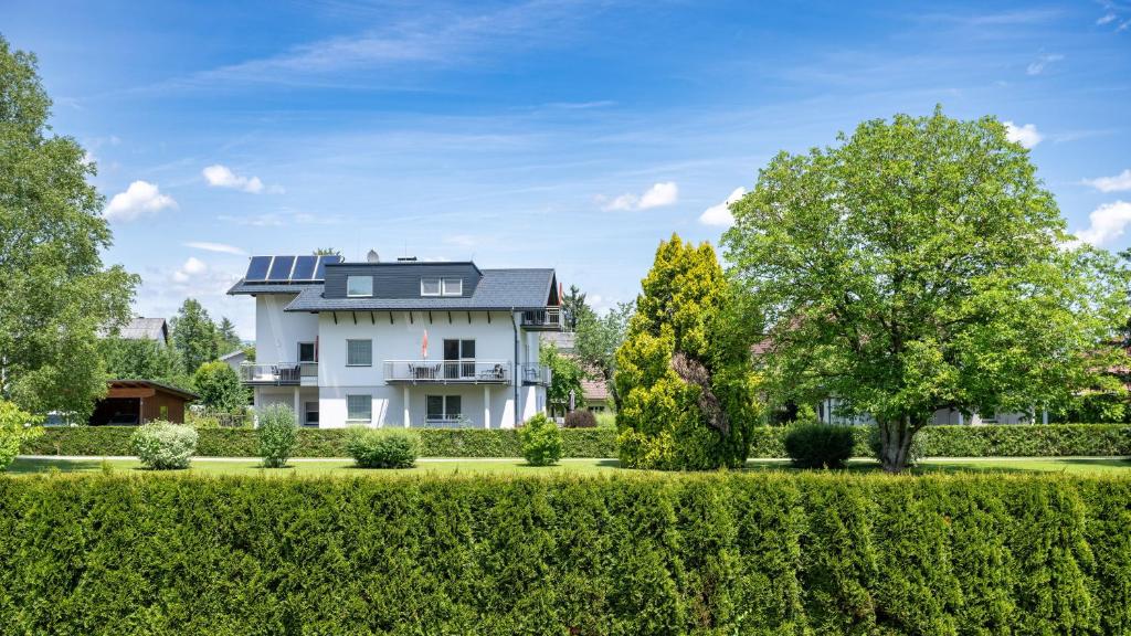 a large white house with trees and bushes at Appartement In Unterburg Am Klopeiner See in Unterburg am Klopeiner See