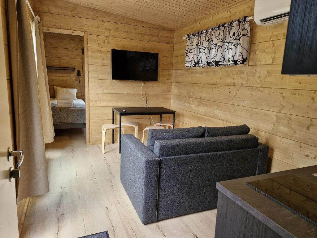 a living room with a couch and a table at Rauhalahti Holiday Homes in Kuopio