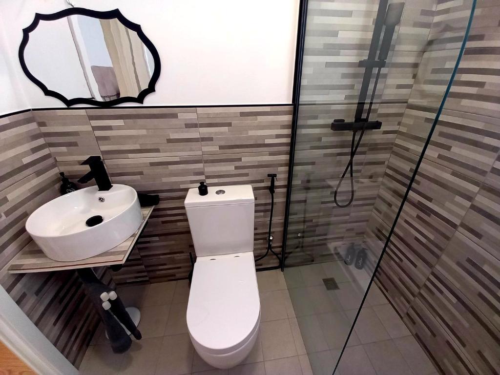 a bathroom with a toilet and a sink at Casa Nilva Holiday in Sanremo in Sanremo