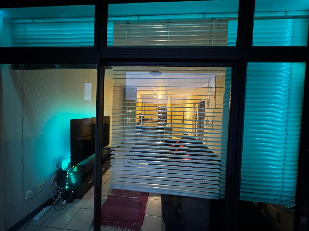 a view of a room through a glass window at Lakeside 2 Bedroom apartment in Tyger Valley