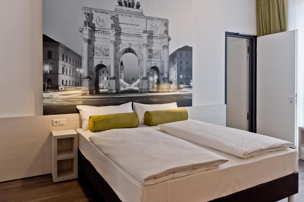 a bedroom with a large bed with a painting on the wall at Super 8 by Wyndham Munich City North in Munich