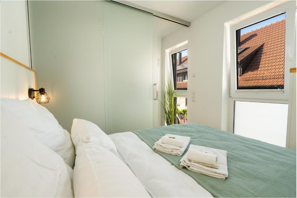 a white couch in a room with a window at Sali Homes Apartmenthaus Schlossgasse in Neckarsulm