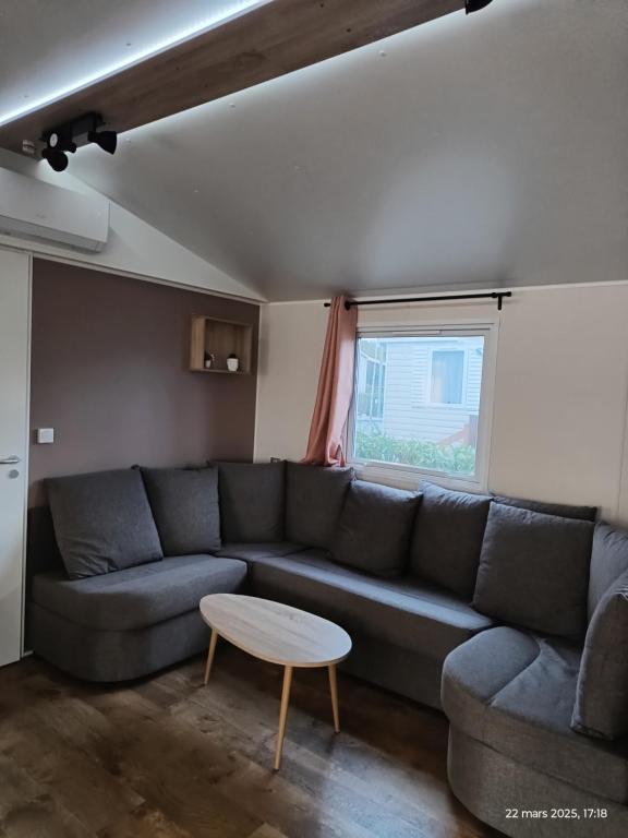 a living room with a couch and a table at Camping siblu Valras-Plage in Valras-Plage