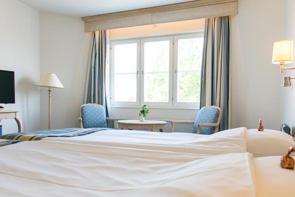 Postel nebo postele na pokoji v ubytování Hotel Mölndals Bro