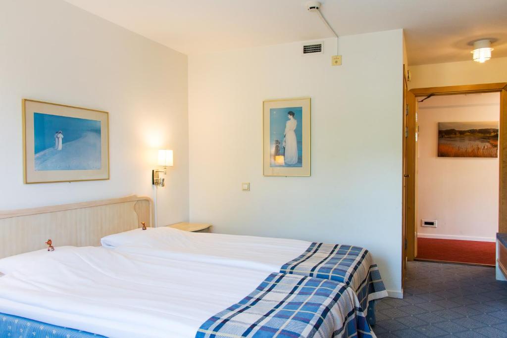 Postel nebo postele na pokoji v ubytování Hotel Mölndals Bro