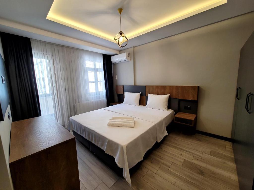 a bedroom with a large white bed in a room at Levent Apart in Trabzon