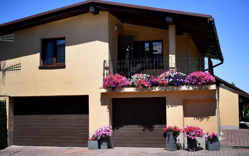 a house with flower boxes on the balcony at Domek pod Zatorem in Ryczów