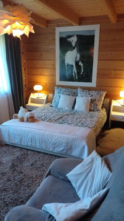 a bedroom with a bed with a picture of a horse on it at Zacisze in Kościelisko