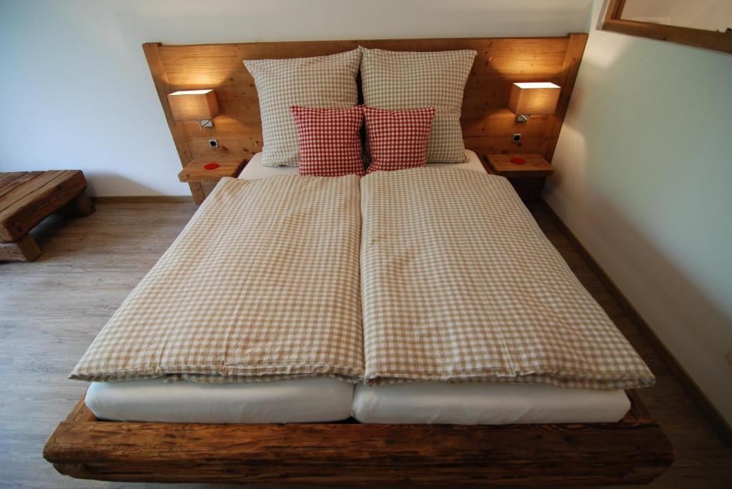 a bed with two pillows on it in a room at Apartment Fischerbräuwiese in Bad Reichenhall