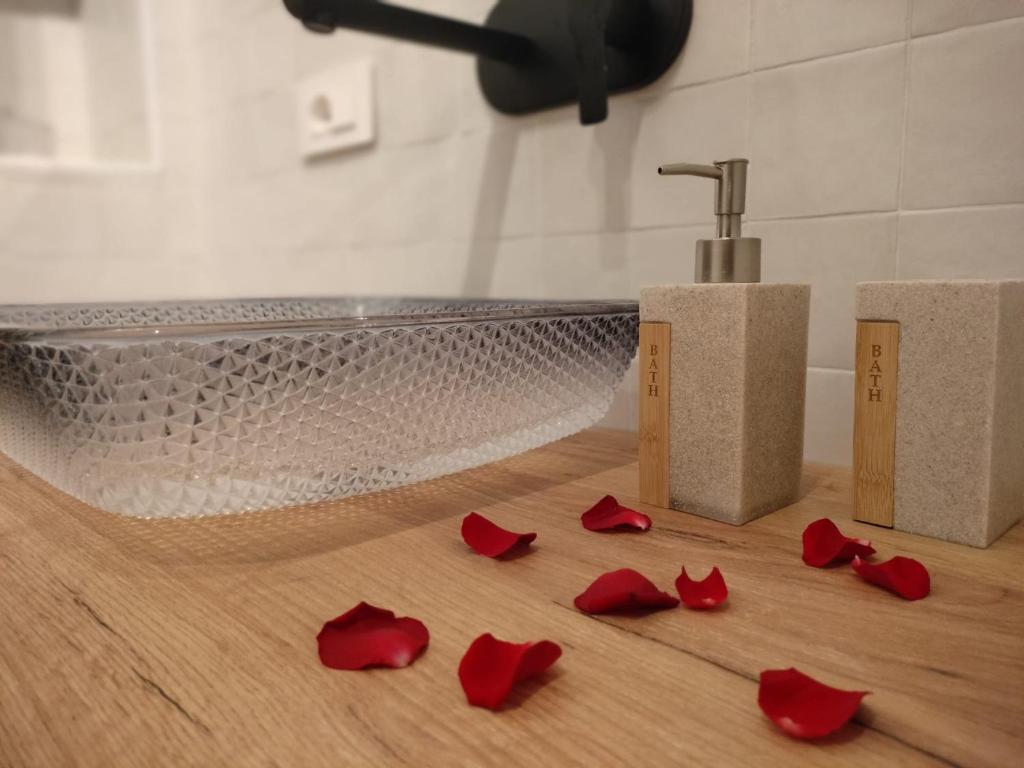a pile of red rose petals on a bathroom floor at Luxmedieval House in Perugia