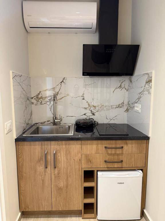 a kitchen with a sink and a counter top at Rasu Apartments in Sarandë