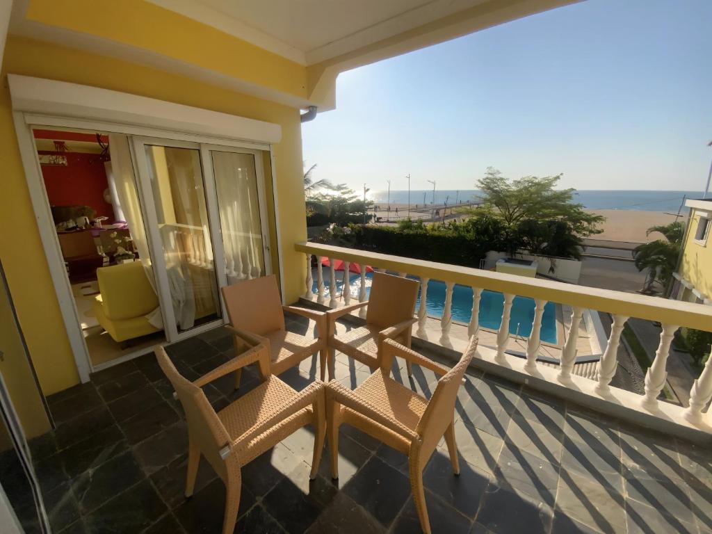 a balcony with chairs and a view of the ocean at Villa Sahitia Marine in Mahajanga