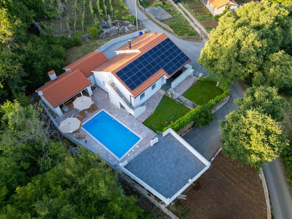 an overhead view of a house with solar panels on the roof at Holiday house with a swimming pool Zmijavci, Zagora - 24240 in Zmijavci