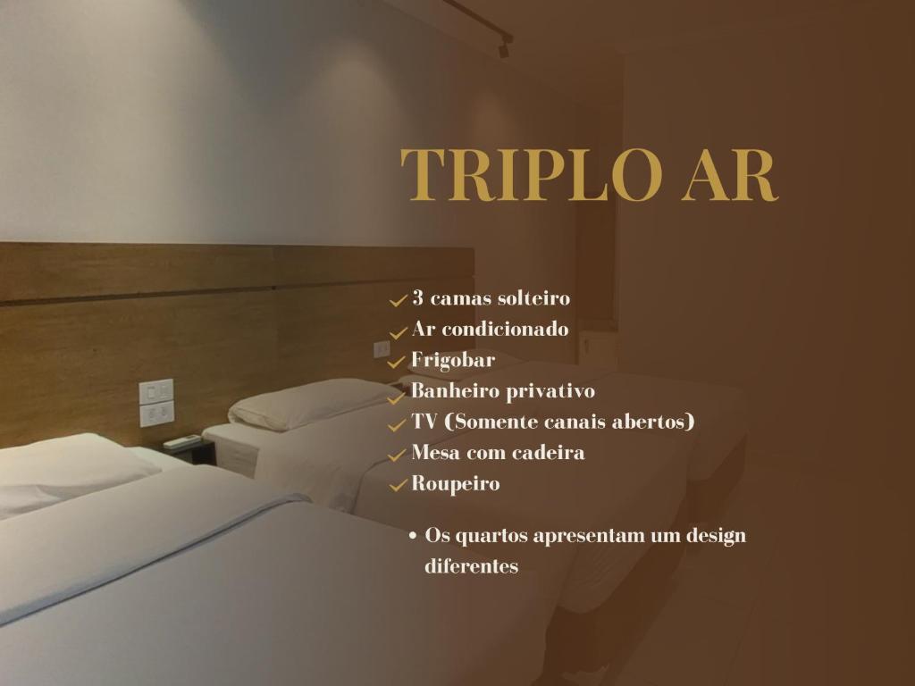 a hotel room with a bed and a sign on the wall at HLN Hotel - Expo - Anhembi in São Paulo