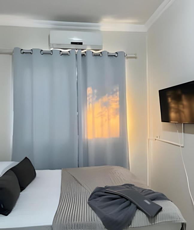 Ένα ή περισσότερα κρεβάτια σε δωμάτιο στο Estadias longa e tranquila - UEM