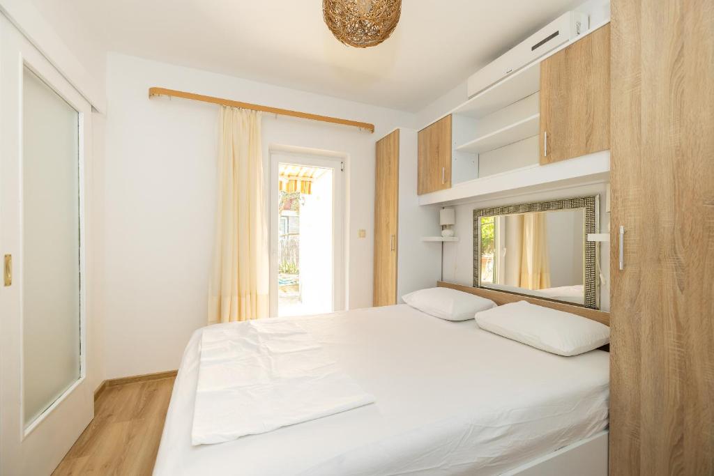 Posteľ alebo postele v izbe v ubytovaní tiho's apartments