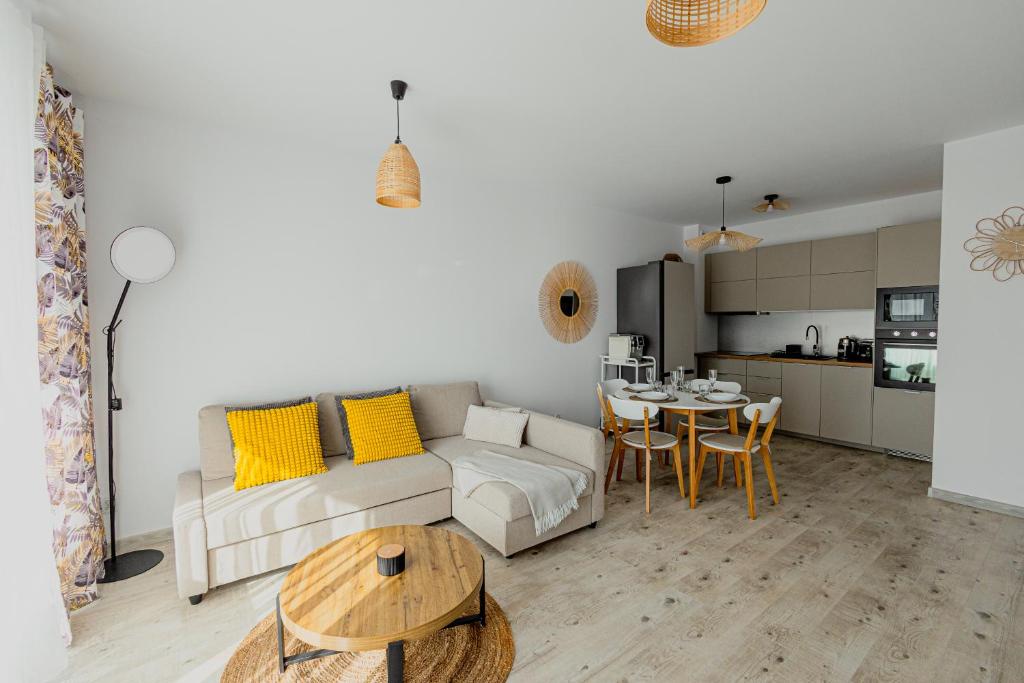 a living room with a couch and a table at Resort Apartamenty Klifowa Rewal 97 in Rewal