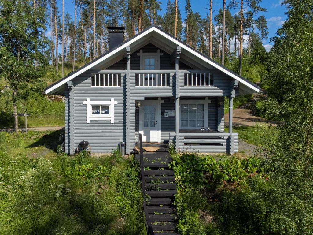 a blue tiny house in the woods at Holiday Home Eteläranta by Interhome in Hara