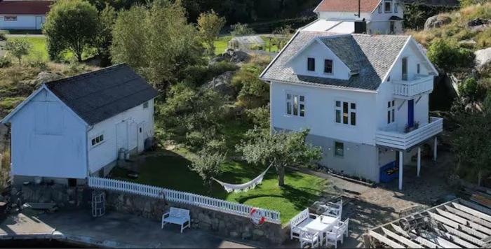 an aerial view of a large white house at Hytte ved sjøen på Andabeløy in Flekkefjord
