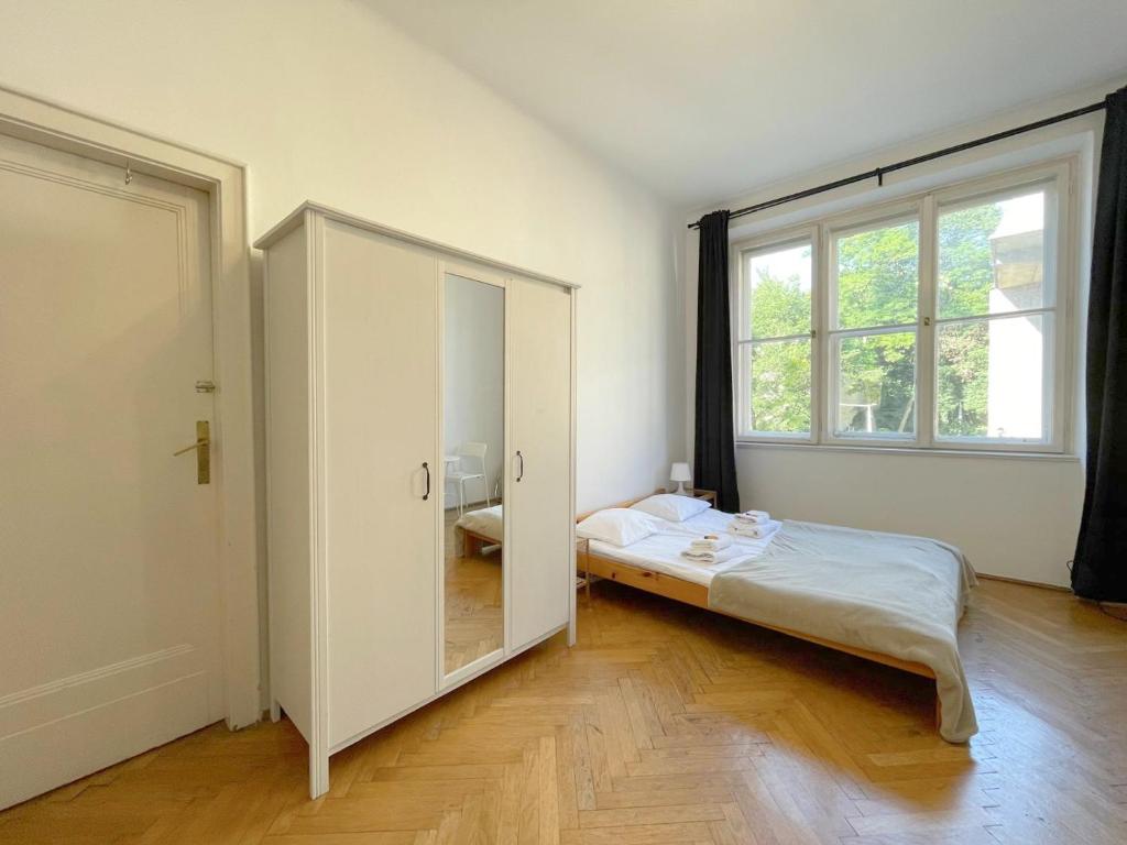 a bedroom with a bed and a large mirror at Retro Apartmentments Łobzowska street in Kraków