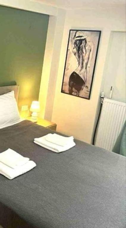 a bedroom with a bed with two towels on it at Nostos in Nea Moudania