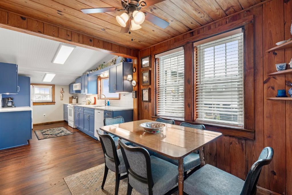 a kitchen and dining room with a table and chairs at The Barn in Kill Devil Hills