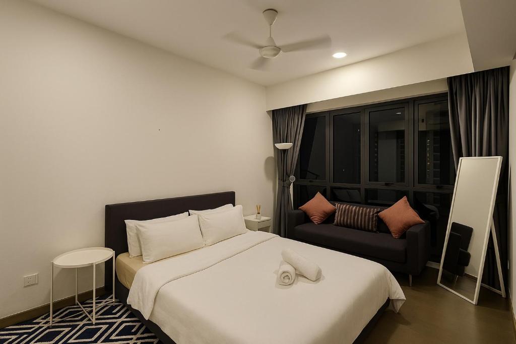 a hotel room with a bed and a chair at Ooak Residence in Mont Kiara, Kuala Lumpur in Kuala Lumpur