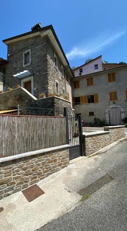 a house with a wooden gate and a fence at Casetta sotto il Monte Forato in Stazzema