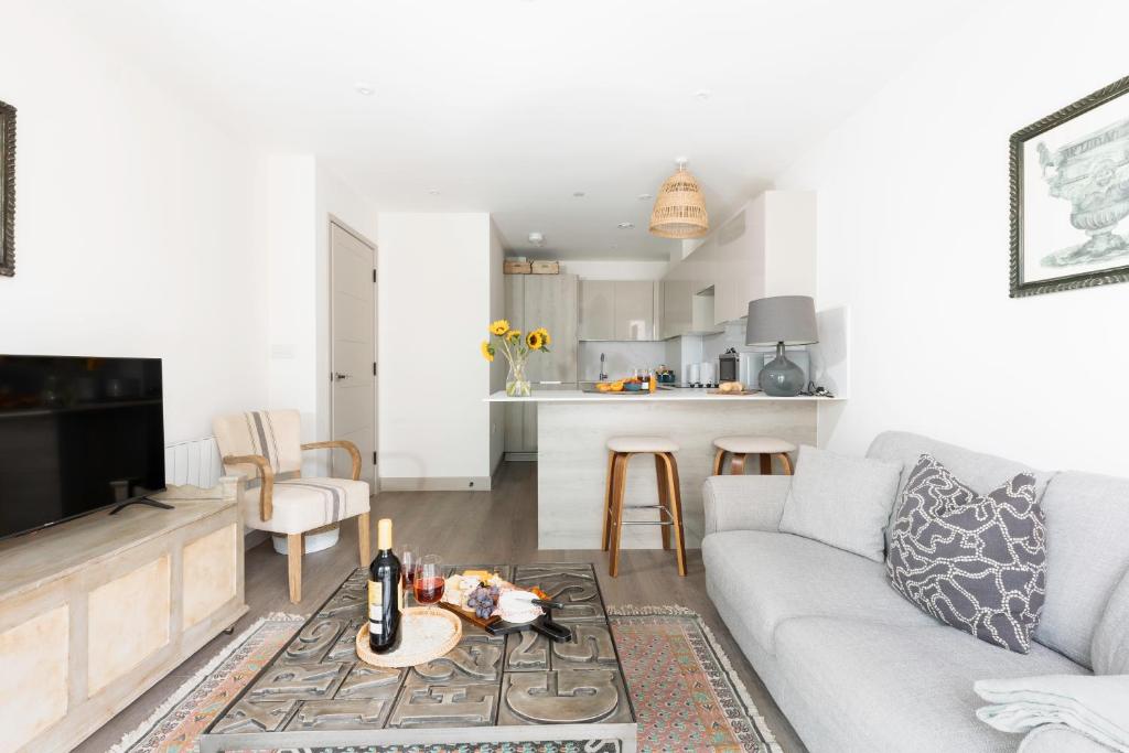 a living room with a couch and a table at Vespasian's Abode by Grandeur Property in Poole