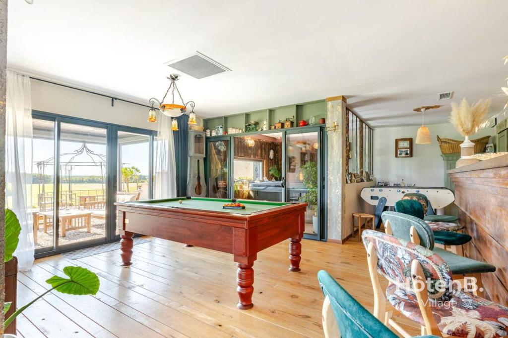 a living room with a pool table in it at Cottage Mamie Yvette Private Spa in Blanc