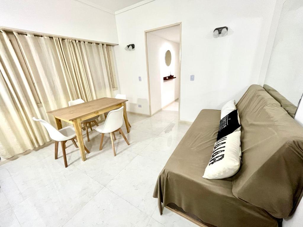 a living room with a couch and a table at Alsina Mdq in Mar del Plata