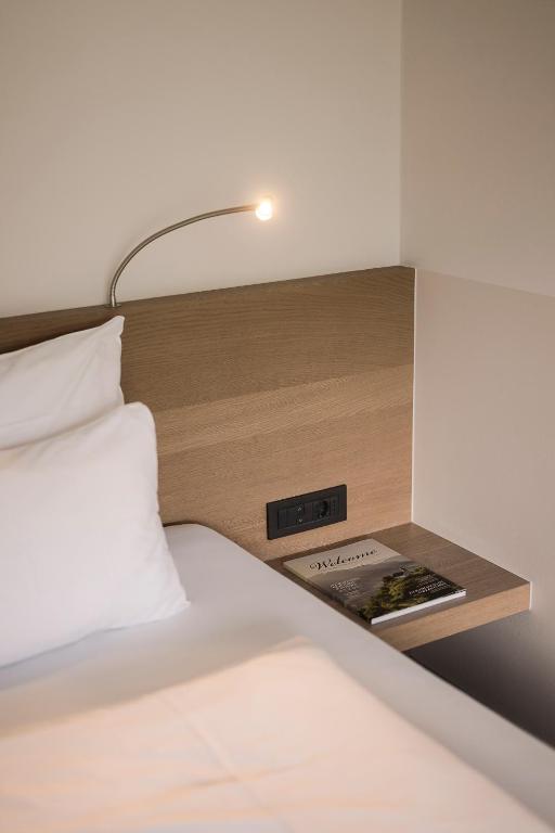 Postel nebo postele na pokoji v ubytování Boutiquehotel Minigolf